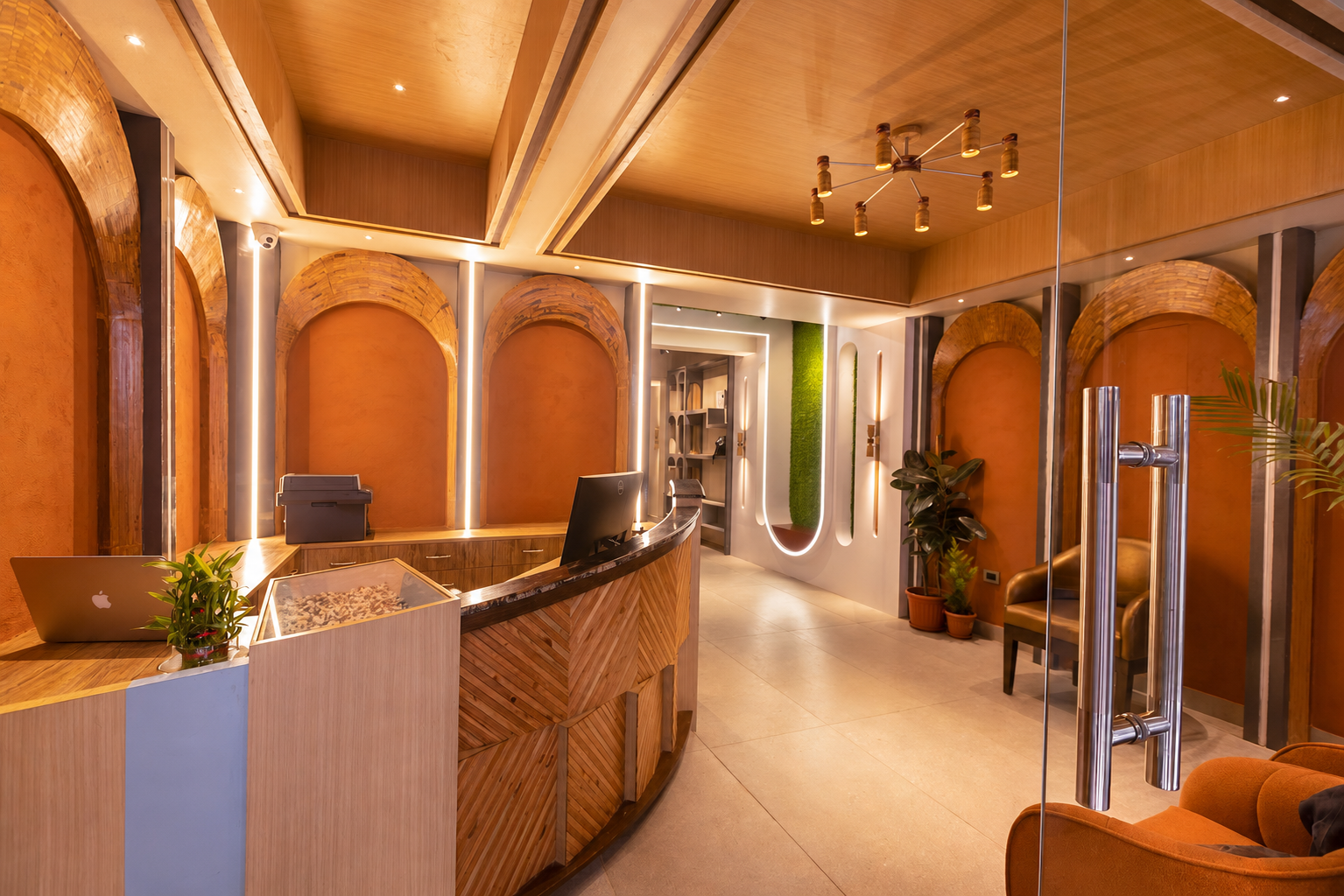 Ananta Home reception &mdash; golden arched columns and warm ambient light